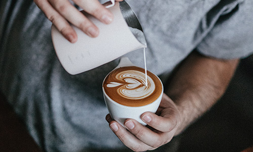 barista pouring coffee - coffee art